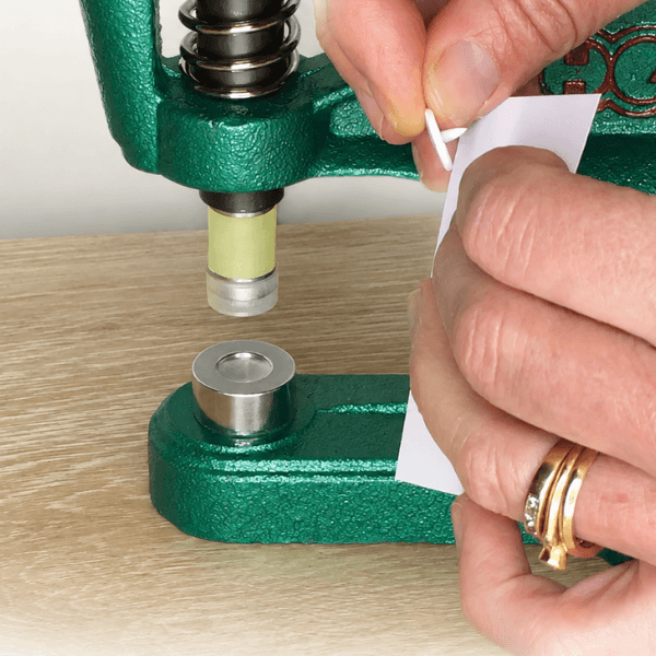Positioning fabric between plastic snap components