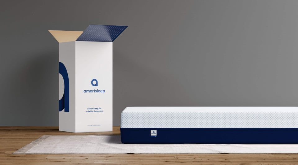 Amerisleep mattress beside a branded shipping box
