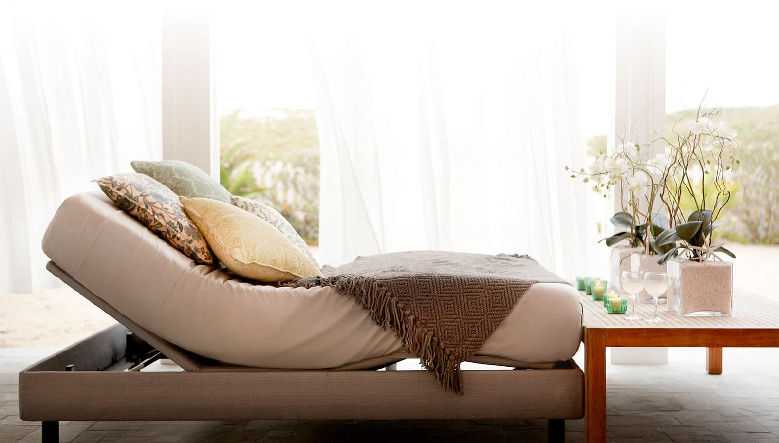 Amerisleep Adjustable Bed sitting in a sunny, bedroom setting.