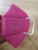 A single pink KN95 mask by Powecom, displayed against a clean background.