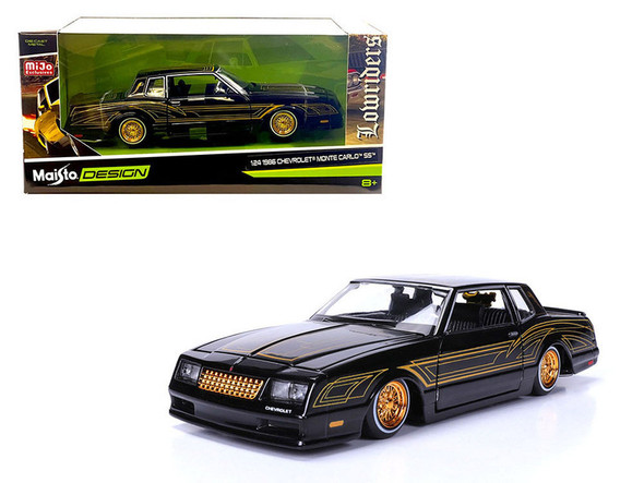 1986 Chevrolet Monte Carlo SS Lowrider Black Metallic with Gold Graphics and Wheels "Lowriders" Series 1/24 Diecast Model Car by Maisto