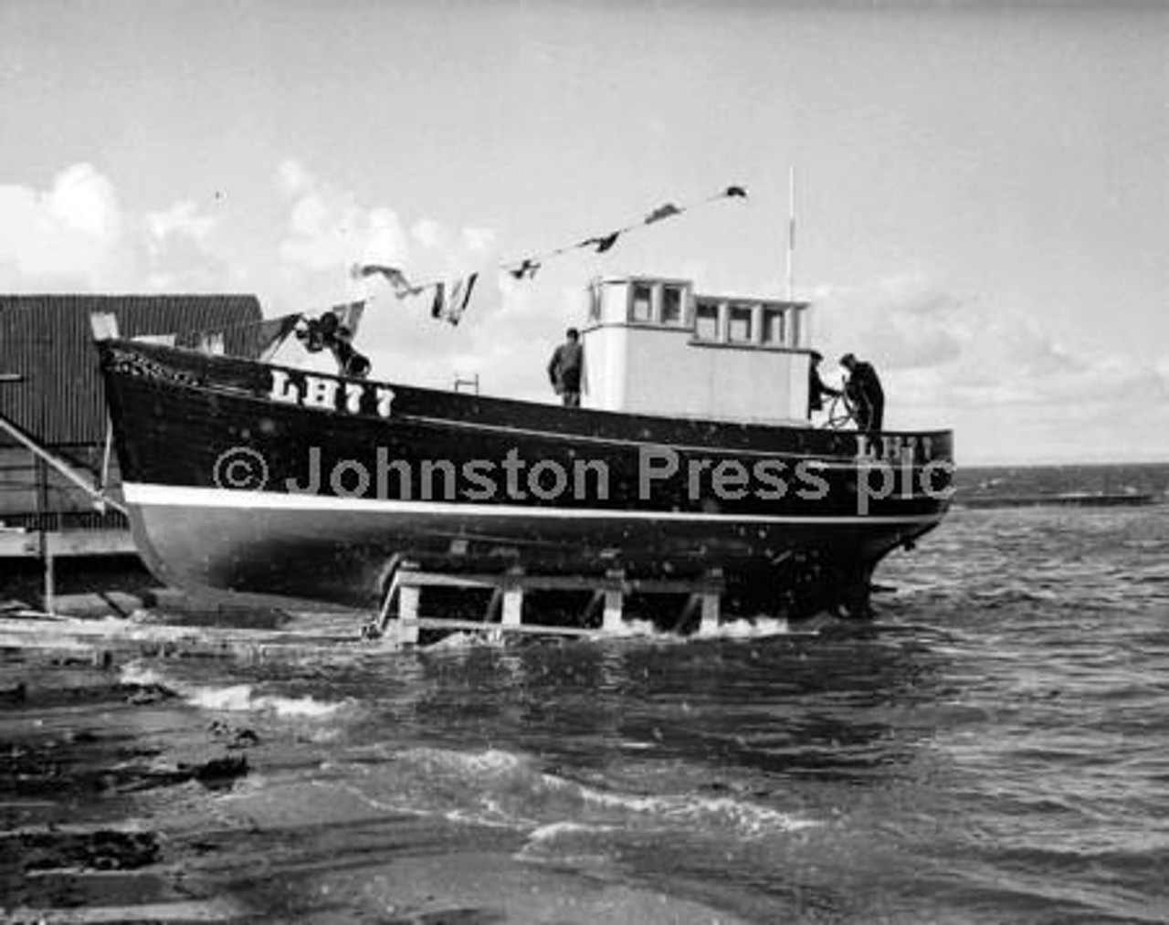 20923345-Launching of Star of Faith seine net fishing boat at Port Seton  Going down the slipway