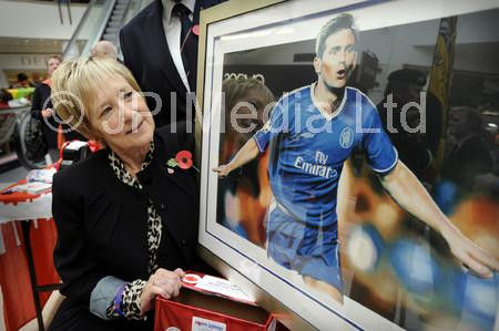 38592450-Beryl Anderson, poppy appeal organiser of the Scarborough branch of the Royal British Legion, with the signed portrait of football star Frank