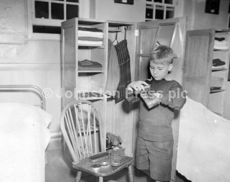 20873932-A little boy called Robert Scott cleaning and polishing