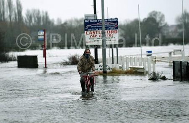 38879571 A cyclist passes through the flood water on the closed