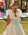 AD Shots provided by Rosa Clara show the dress in IVORY/GREEN