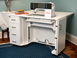 Horn Model 5400 Electric Lift Sewing Cabinet with a 25" x 13" machine cut-out, "Whisper Quiet" electric lift, four storage drawers, and a hinged drop leaf for additional workspace. Horn Model 5400 Electric Lift Sewing Cabinet with a 25" x 13" machine cut-out, "Whisper Quiet" electric lift, four storage drawers, and a hinged drop leaf for additional workspace.