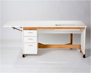 The Tracey Stables Quilters Cabinet offers a spacious 61½" x 24" workspace, three drawers, breadboard, 17" side leaf, and optional pneumatic lift. The Tracey Stables Quilters Cabinet offers a spacious 61½" x 24" workspace, three drawers, breadboard, 17" side leaf, and optional pneumatic lift.