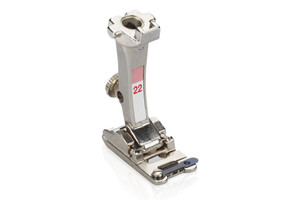This foot is ideal for couching multiple yarns, woolen thread, or cording at the same time to produce a decorative trim or braid effect on garments and home furnishings.
The swing-out latch on top of the foot holds the yarn or cords securely in place and prevents them from tangling during the sewing process. The result is a neat, consistently stitched braid-like embellishment. This foot is ideal for couching multiple yarns, woolen thread, or cording at the same time to produce a decorative trim or braid effect on garments and home furnishings.
The swing-out latch on top of the foot holds the yarn or cords securely in place and prevents them from tangling during the sewing process. The result is a neat, consistently stitched braid-like embellishment.