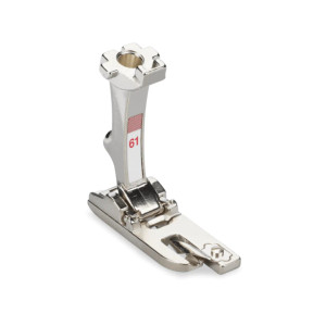 This foot is designed for hemming light-weight fabrics. The fabric is fed into the guide of the sole, which turns the edge under twice. The guide holds together the turned hem until it reaches the needle. The fabric edge is then sewn with a zigzag stitch into a narrow, sturdy hem which advances easily under the foot.
Sews very narrow 2mm wide hems. This foot is designed for hemming light-weight fabrics. The fabric is fed into the guide of the sole, which turns the edge under twice. The guide holds together the turned hem until it reaches the needle. The fabric edge is then sewn with a zigzag stitch into a narrow, sturdy hem which advances easily under the foot.
Sews very narrow 2mm wide hems.