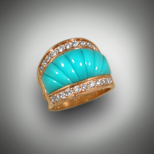 Seven pieces of Sleeping Beauty Turquoise create a wide band of color. This
14 Kt yellow gold ring is framed by twenty-two pave' set Diamonds on top and bottom
(total weight 1.00 ct F/G color, VS+ clarity). Measuring almost 3/4 inch across at the
top and tapering to a 1/4 inch at the back, this band is both comfortable and striking !!