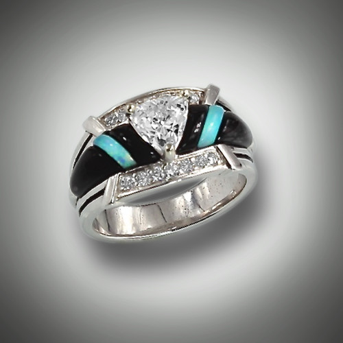 R 801 center stone is a 6mm trillion cut renzite with 18 points of F/VS pave` diamonds hand carved pieces of turquoise and black jade inlay set in 14kt white gold.