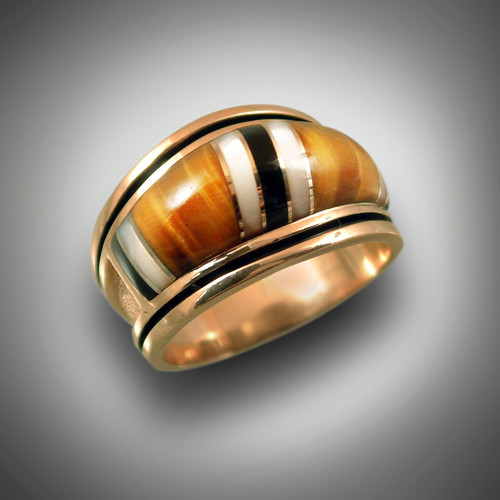 RB 1 has hand carved tiger eye stones with mother of pearl and black jade and 8 gold dividers all set in 14kt yellow gold. 