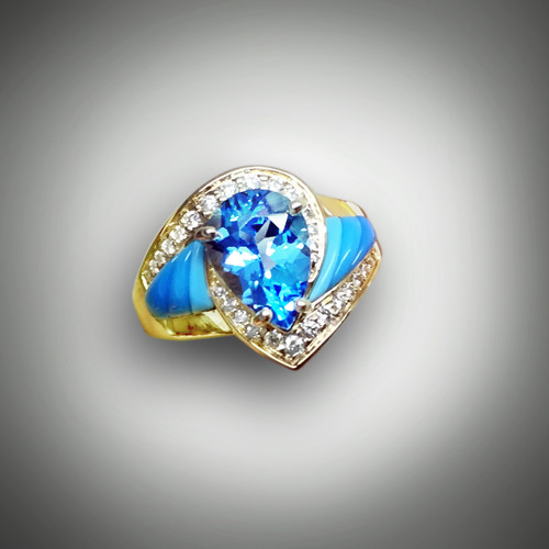 R 510 has a10x7mm Swiss blue pear shaped topaz set with graduated turquoise stones with 31 pave' F/VS1 .55 points diamonds in 14kt yellow gold.  