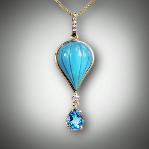 PND 159-A. Balloon pendant with hand craved turquoise inlay with a 0.5pt F/VS diamond, and a 0.4pt pave` bail with a 1.85ct pear shaped swiss blue topaz set in 14kt yellow gold.