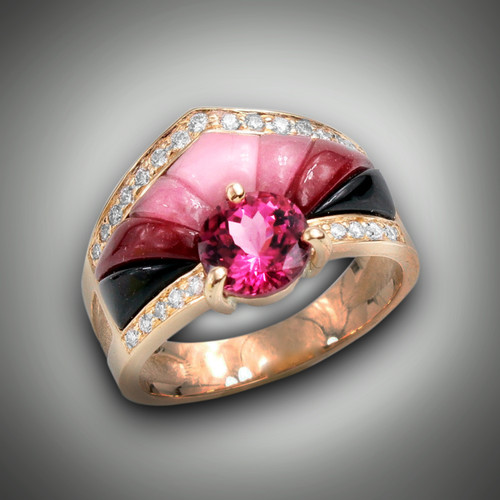 R 1056
Has a 1.4ct 7mm round rhodolite garnet with 0.44ct F/VS pave diamonds, inlaid with sugilite, rhodonite, and maroon jasper, set in 14kt yellow gold.