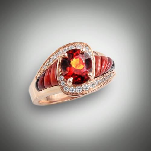 R-510 Hessonite Garnet has a 7.5 by 6.5 mm Oval Hessonite garnet surrounded by 24 (.28ct) F/VS pave diamonds with hand carved inlay pieces of orange, red, maroon jasper's, and black jade set in 14 kt rose gold. 