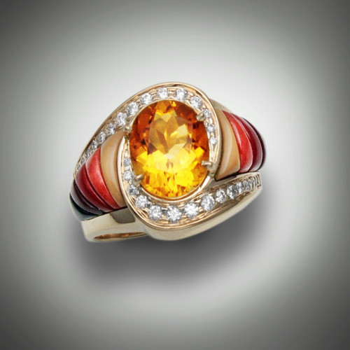 R-510 Citrine has a 10 by 8mm oval amber citrine surrounded by 36 pave` F/VS diamonds weighting 0.75ct, the sides have hand carved inlay stones are cream, red and maroon jaspers with black jade on the ends set in 14 karat yellow gold.