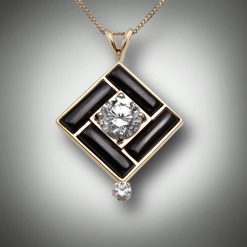 Pendant 238 has a center stone 8.5mm renzite with a 10 point F/VS diamond on the bottom the inlay stone is hand carved black jade and it is set in 14 karat yellow gold.