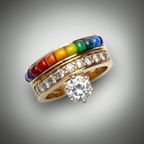 R 884 A and B has a 6mm, 0.85ct I/SI1 round center diamond with 55 points of F/VS diamonds and the inlay stones are dark lavulite, medium lavulite, maroon jasper, red-orange jasper, yellow jasper, green lime opaline, chrysoprase, and light and dark lapis set in 10.6 14kt yellow gold.  