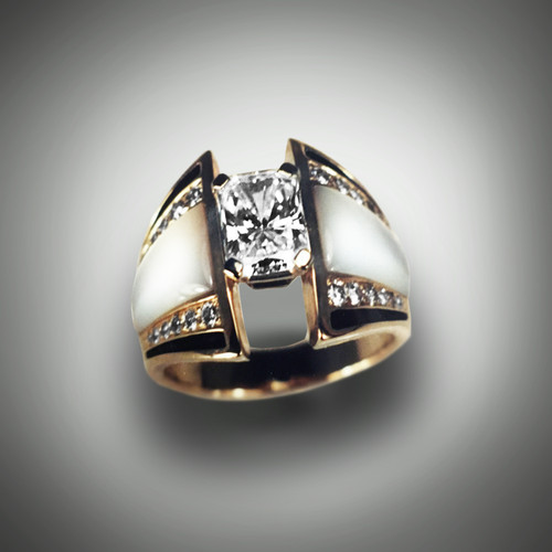 We like it just as shown, though if you have ideas please let us know. Opalescent Mother of Pearl framed by pave' set Diamonds enhance the larger Radiant Cut Diamond in center. Yellow Gold.