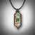 This beautiful pendant is set in 14kt white gold with multicolored sapphires and garnets with black pave diamonds.  The gorgeous center stone is a round cut tsavorite garnet.