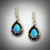 ER 218 earrings have a 10x7mm pear shape opal with a 2 point F/VS diamond, and hand carved black jade inlay with a lever-back settings set in 14kt yellow gold.