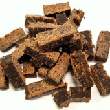 Eden Holistic Lamb and Game Dog Treats, showing a handful