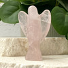 Hand-carved Rose Quartz Angel figurine standing upright, showcasing soft pink tones and smooth polished finish. Used for healing, love, and spiritual connection.