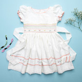Ivory swiss dot hand-smocked dress with pastel embroidery