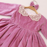 subtle embroidered accents on bodice and lace collar