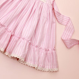 a subtle pink mini stripe ruffle skirt has with eyelet lace tims and a pintuck-detailed bodice.