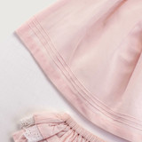 Subtle horizontal pintucks featured at the hem