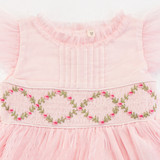 Tulle-detailed neckline and flutter sleeves paired with a beautifully hand-smocked embroidered bodice.