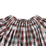 A delicate smocking around the neckline