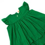 a hand-embroidered button on the pleated yoke.