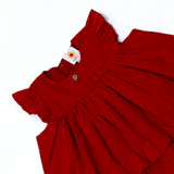 flutter sleeves and pleated yoke with hand-embroidered buttons