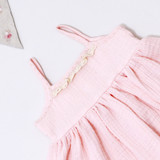 The peach tunic with subtle hand embroidery on the neckline and straps, a lace-trimmed back placket, and an elasticated yoke