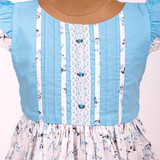 Bodice detailed with elegant pin tucks and finished with white lace trims.