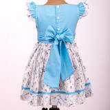 Back-button opening with adjustable back belt ties for a comfortable fit.