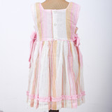 back-button closure with ruffles on the hem and cord piping on the waist