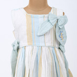 Hand-embroidered bow on the bodice accented with cord piping along the waist.