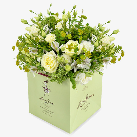Elegance and grace embody this zesty floral bouquet. White roses and lisianthus are intertwined with rich greenery emulating an English country garden.