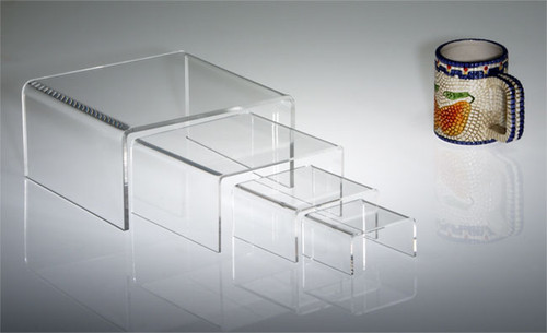 Clear acrylic half-height rectangular risers in multiple sizes, a versatile option for retail display.