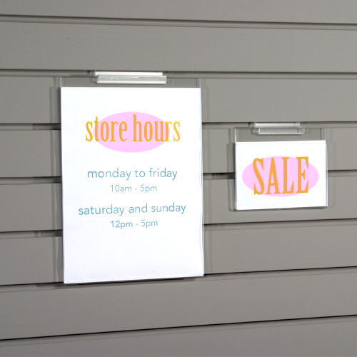 Clear acrylic sign holders for slatwall.