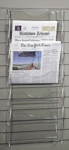 Clear acrylic slatwall mounted newspaper rack with six pockets.