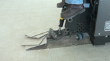 Ride-on scraper removing ceramic tile