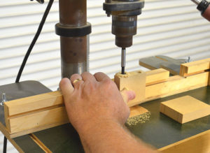 Drilling holes in the face of the sanding block