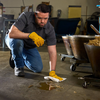 Industrial employee wiping floor with Clean Task Pro Strength T700 White Wipers