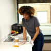 Custodial worker cleaning a commercial surface with Clean Task Eco Z300 natural wipers